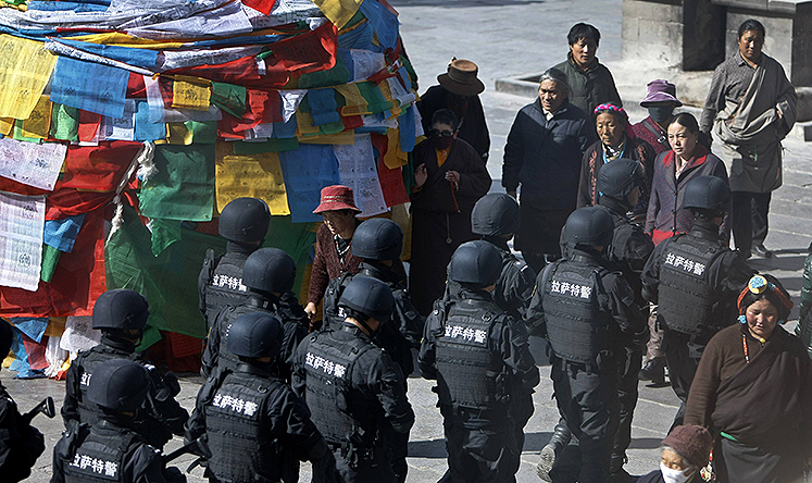 Special Weapons and Tactics police patrol outside the Jokhang monastery in Lhasa. Photo: Reuters