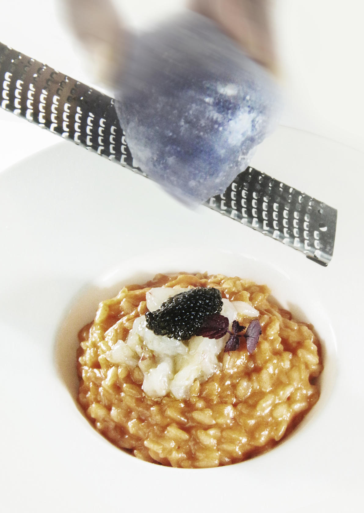 Persian blue salt is grated over red prawn risotto with malossol caviar at Aqua Armani.
