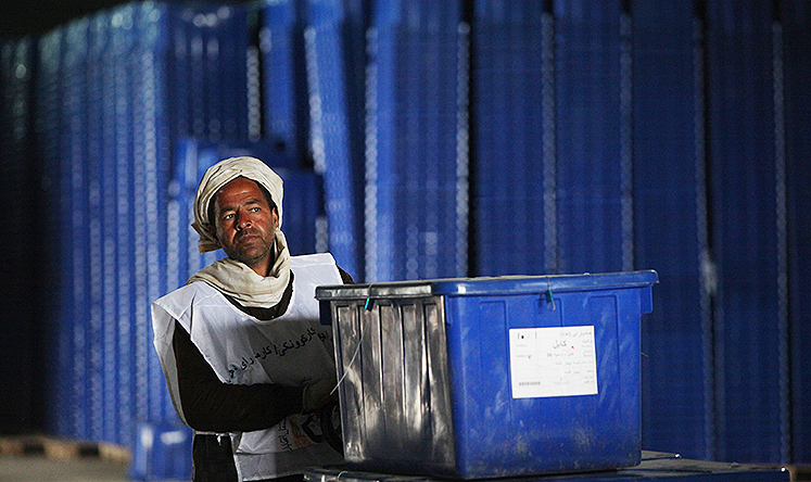 An Afghan election commission worker pushes ballot boxes in IEC warehouse in Kabul. Photo: Xinhua