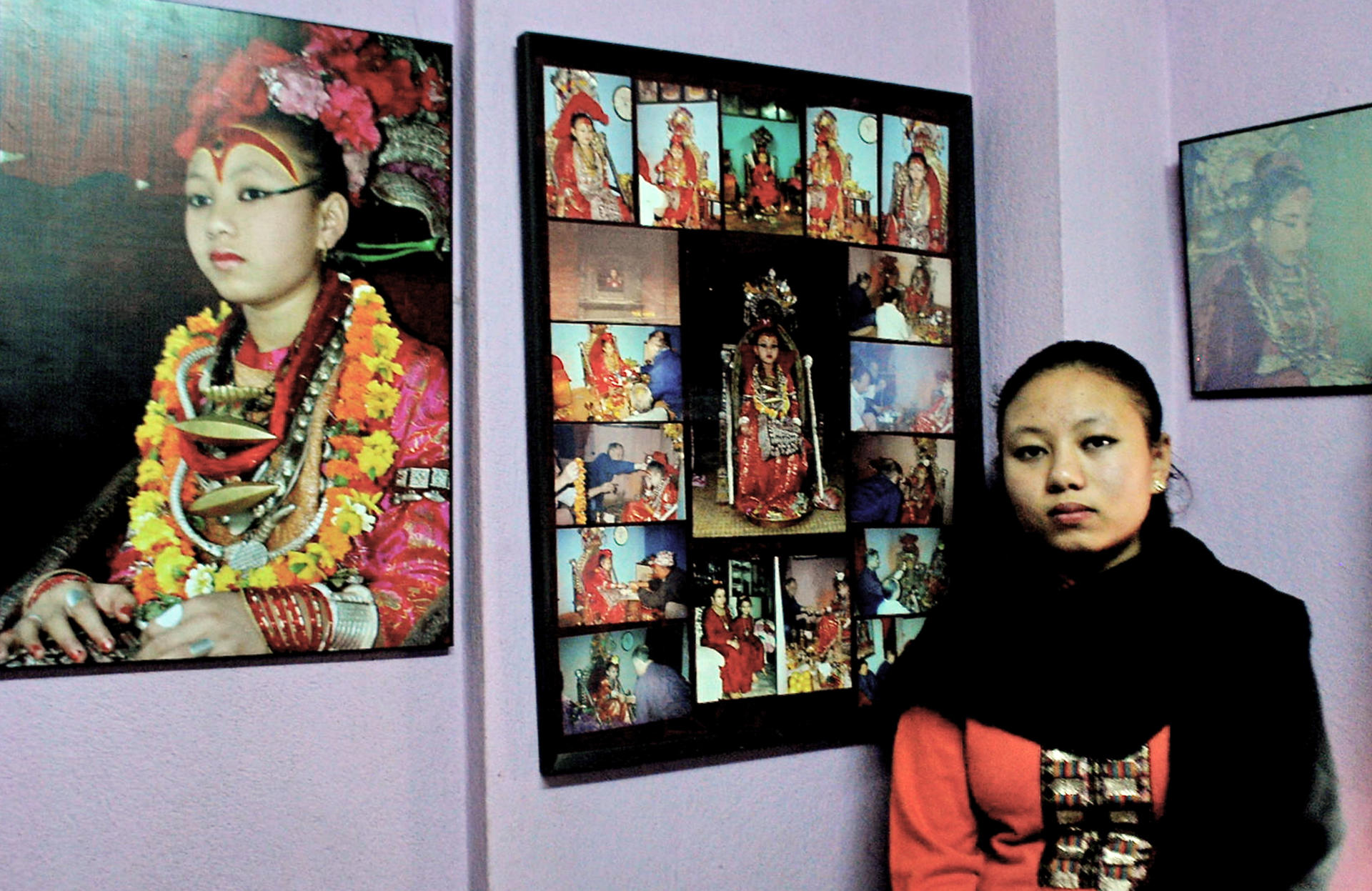 Chanira Bajracharya at home with pictures of her time as a living goddess. She returned to normal life at the age of 15. Photos: Bibek Bhandari