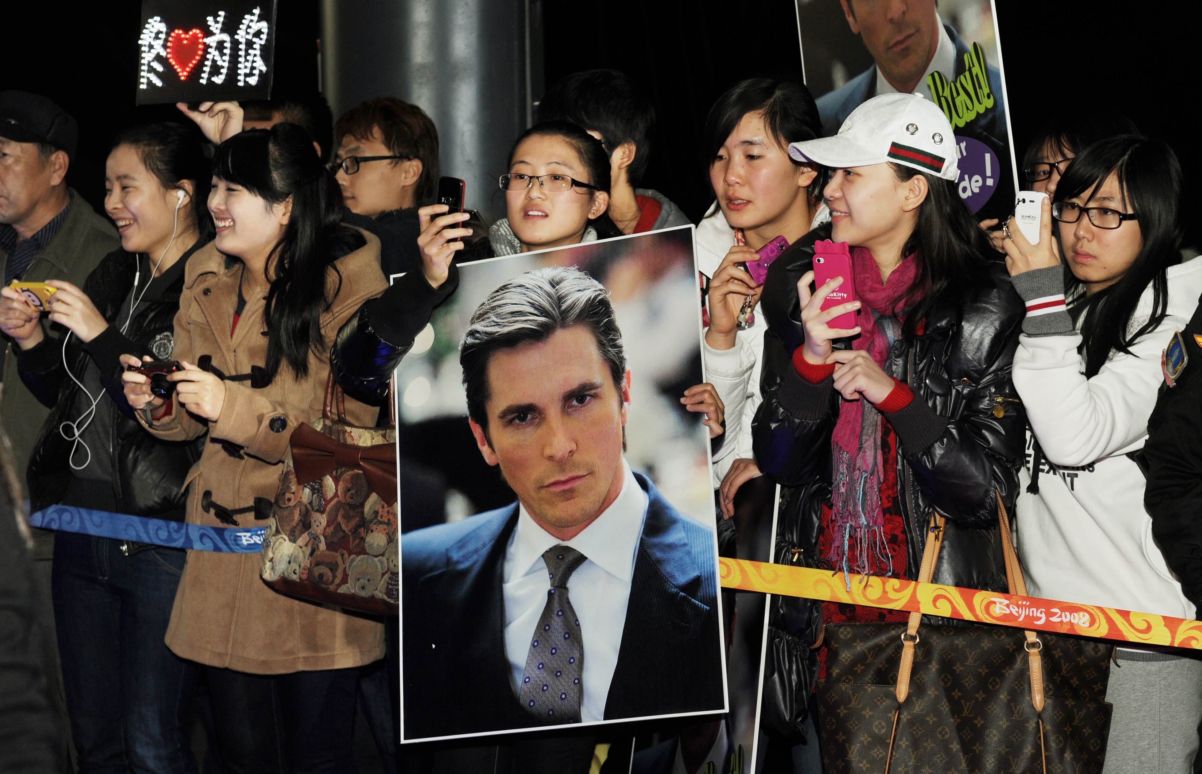 Chinese fans of Oscar winning actor Christian Bale wait as he arrives on the red carpet for the screening of the film "The Flowers of War," in Beijing on December 12, 2011. Photo: AFP