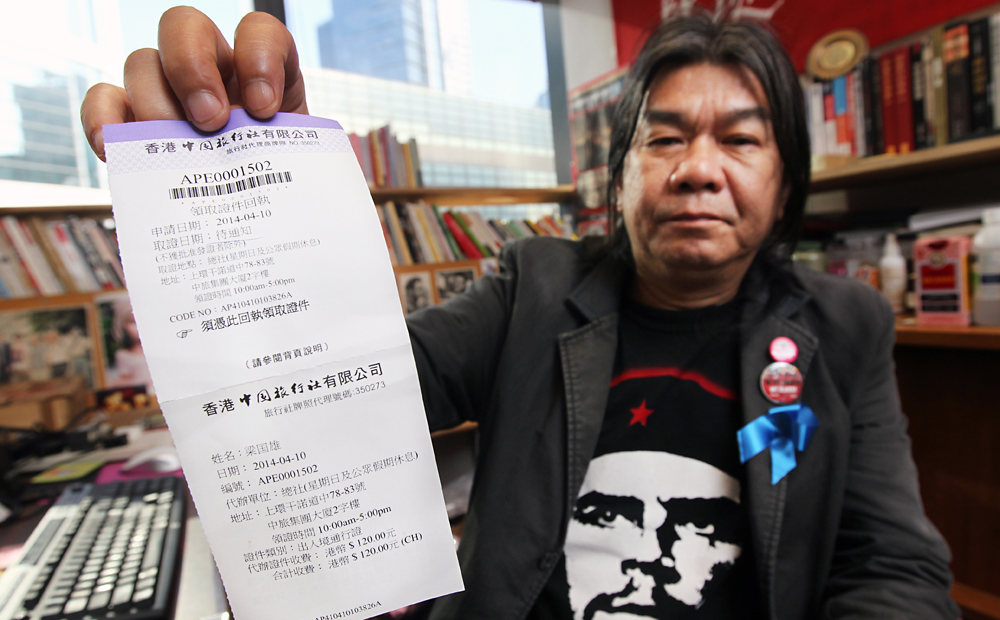 League of Social Democrats lawmaker "Long Hair" Leung Kwok-hung shows a receipt of his one-time home return permit application for the lawmakers' trip to Shanghai. Photo: May Tse