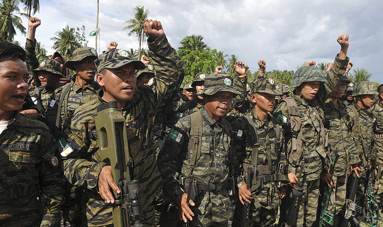 Moro Islamic Liberation Front fighters raise their fists at Camp Darapanan, in the southern Philippines in March. Photo: Reuters 