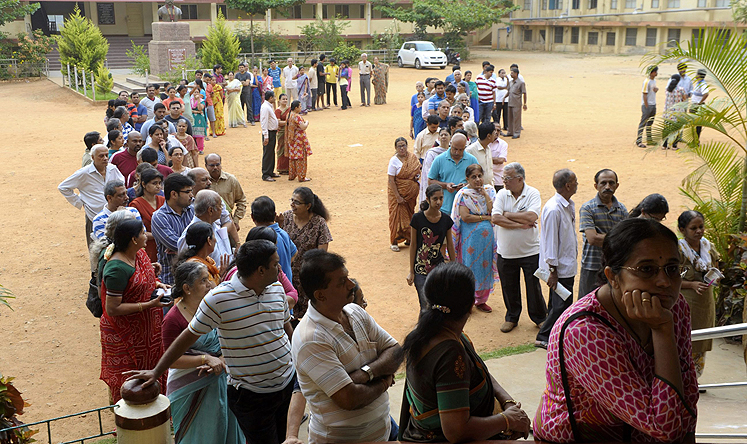 Indian voters wait at a polling station during the fifth phase of the Indian General elections in Bangalore, Karnataka province on Thursday. Photo: EPA