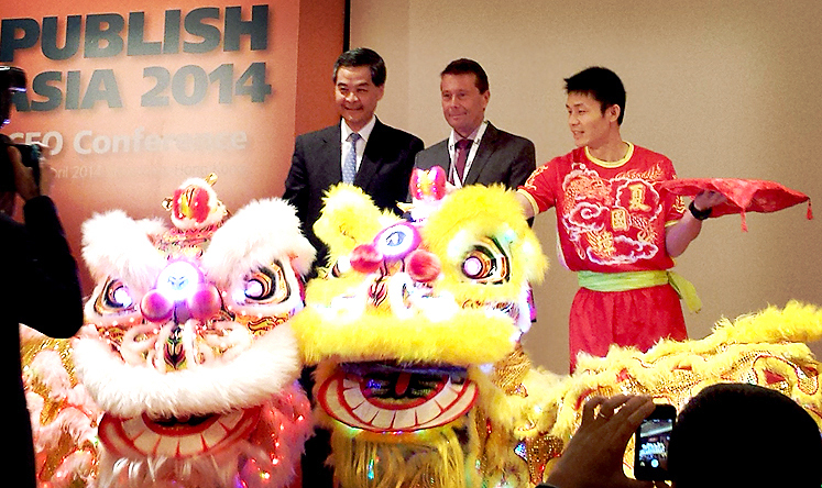 Chief executive Leung Chun-ying joins WAN-IFRA president Tomas Brunegård on stage to open the annual Publish Asia international conference. Photo: Joanna Chiu