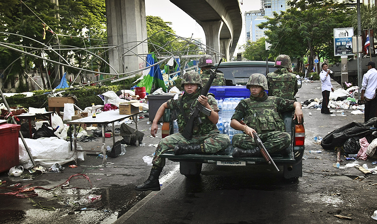 Thai soldiers ride through an area of Bangkok formerly held by anti-government protesters. Photo: AP 