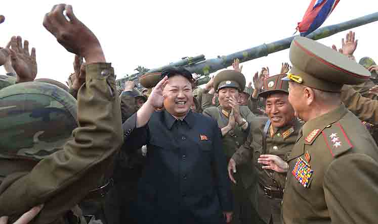 North Korea's leader Kim Jong-un with soldiers of a long-range artillery unit during a firing drill at an undisclosed location. Photo: EPA