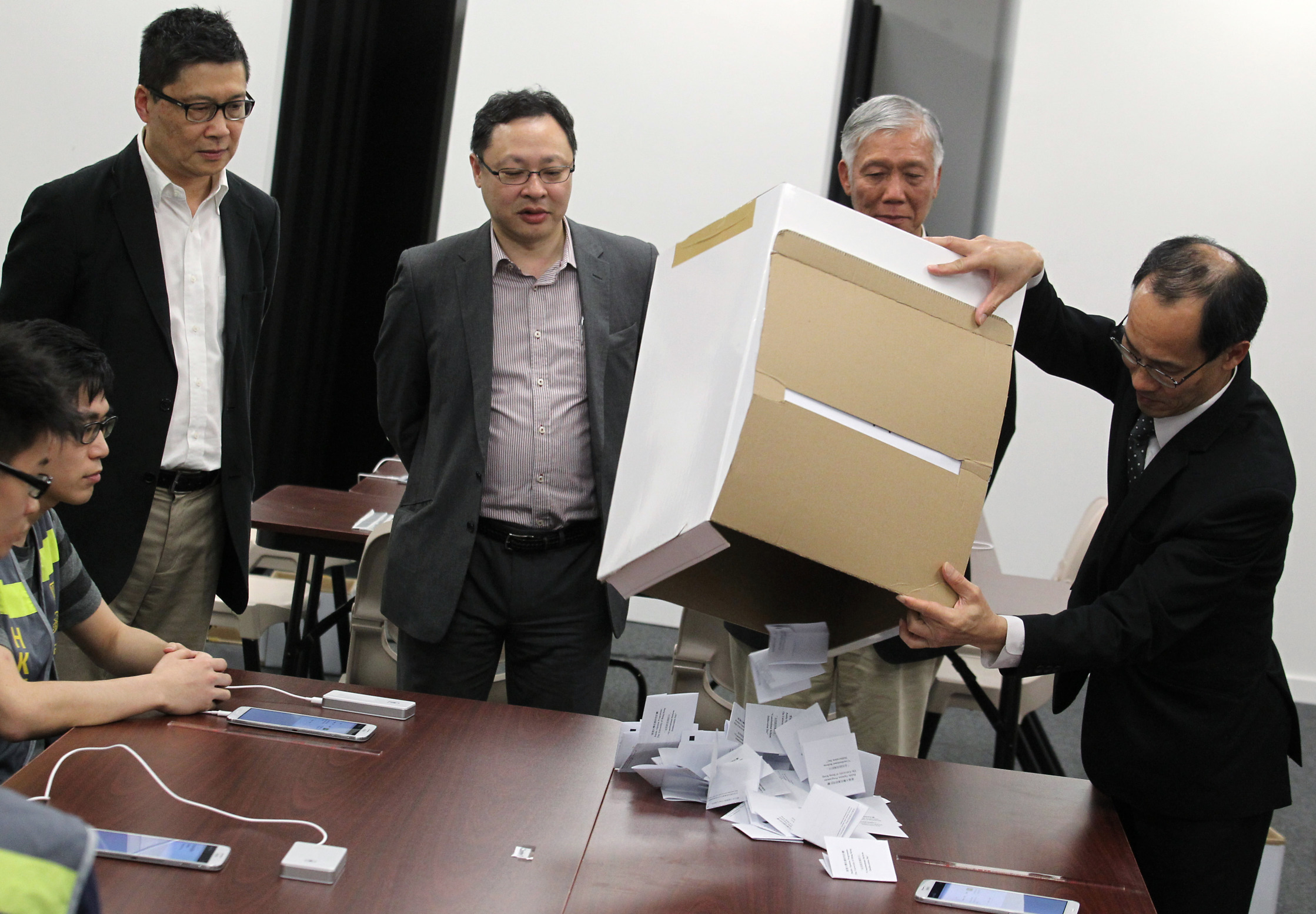 Occupy Central founders (from left) Chan Kin-man, Benny Tai Yiu-ting, Chu Yiu-ming and Dr Robert Chung Ting-yiu, director of the public opinion programme at HKU, open the first "deliberation day" ballot box yesterday. Photo: Dickson Lee
