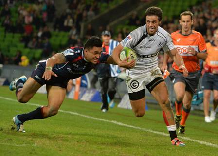 Sharks inside centre Heimar Williams tries to evade Rebels wing Male Sa’u in their Super 15 clash in Melbourne last Friday – a match the Sharks won 22-16. Photo: AFP