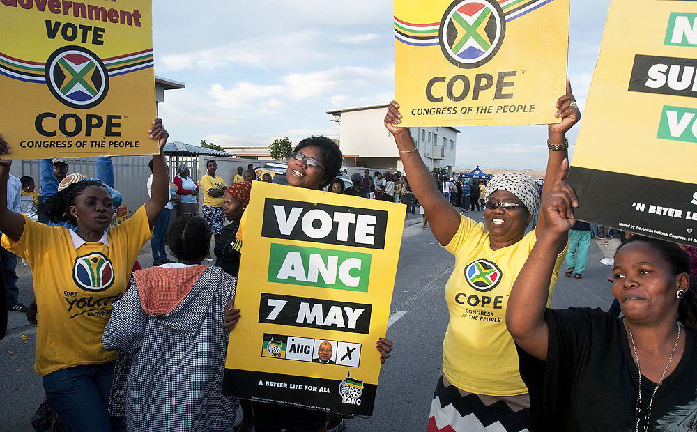 Voters sing and dance next to a polling station close to Cape Town on Wednesday. Photo: AFP