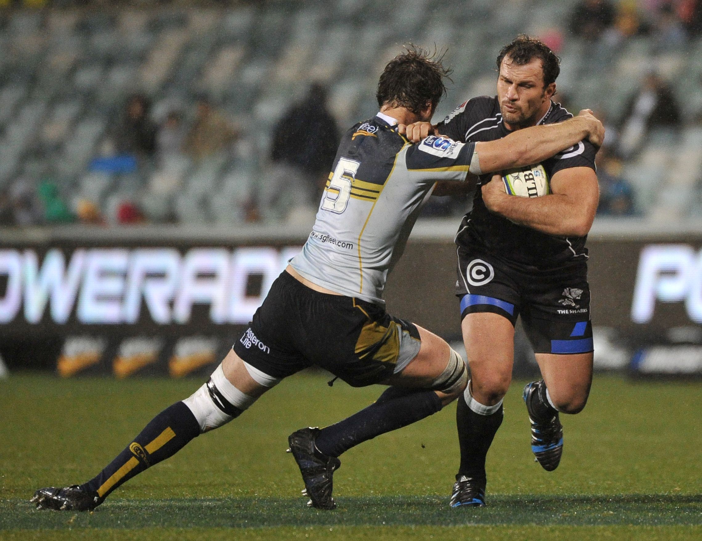 Brumbies' Sam Carter (left) takes on Sharks captain Bismarck du Plessis in their clash in Canberra. Photo: AFP