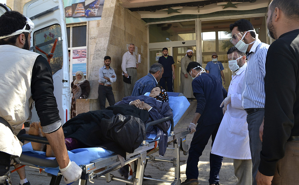 A woman affected by what activists say was a gas attack on Telmans arrives for treatment at Bab al-Hawa hospital, near the Turkish border on April 21. Photo: Reuters
