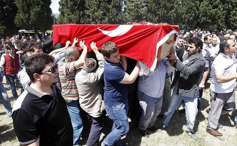 Mourners carry the coffin of a miner who died in the mine, draped with a Turkish flag. Photo: Reuters