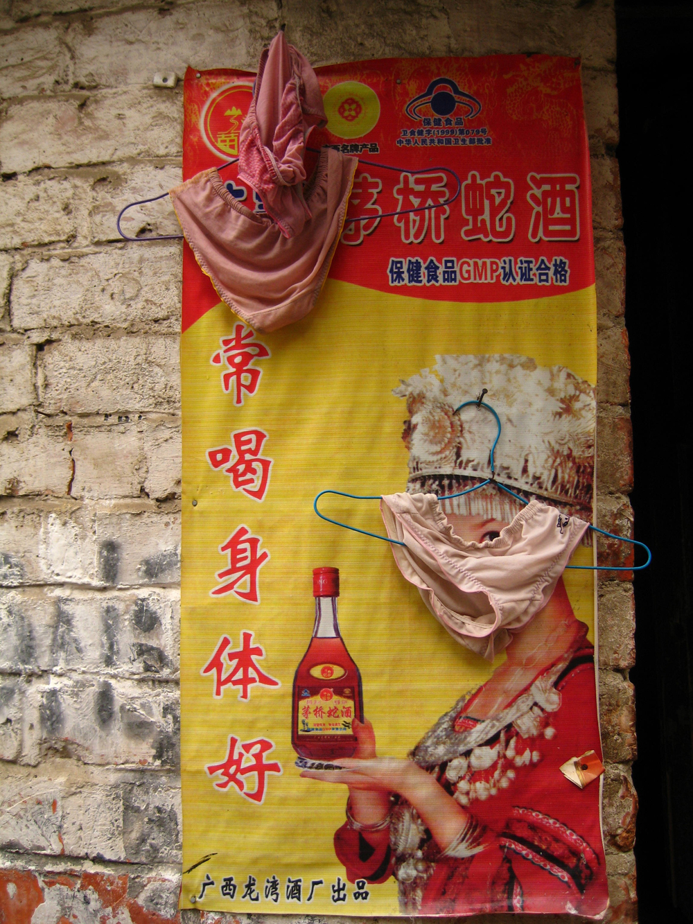 Strip teaser: a poster touting the benefits of snake wine – and 
worn knickers. Photo: Cecilie Gamst Berg