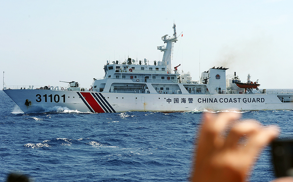 A Vietnamese coastguard officer monitors a Chinese coastguard vessel near China's oil drilling rig in disputed waters in the South China Sea. Photo: AFP