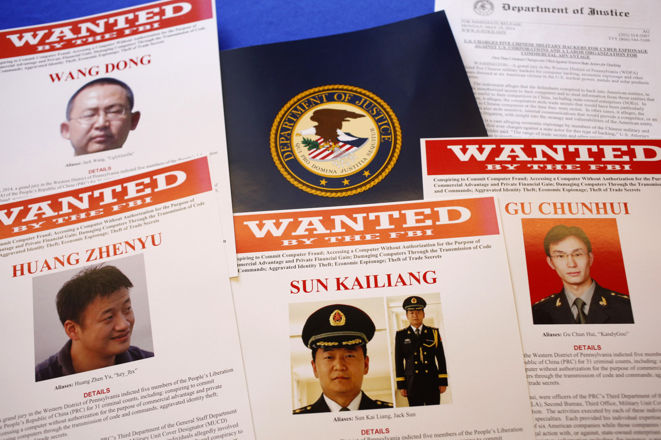 "Wanted" posters of Wang Dong and the other accused. Photo: AP