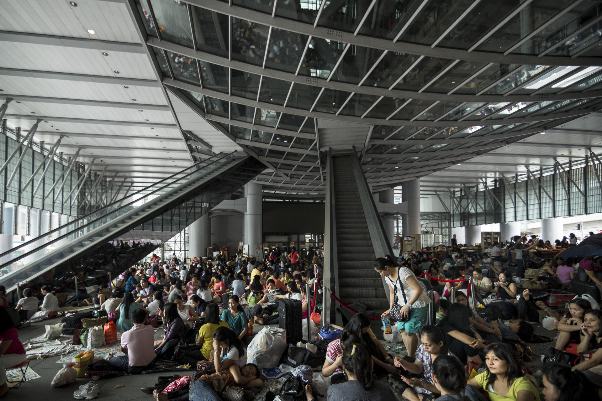 Domestic workers gather in Central on a Sunday, for many their only day off. The helpers are often excluded from protections given to other migrants.