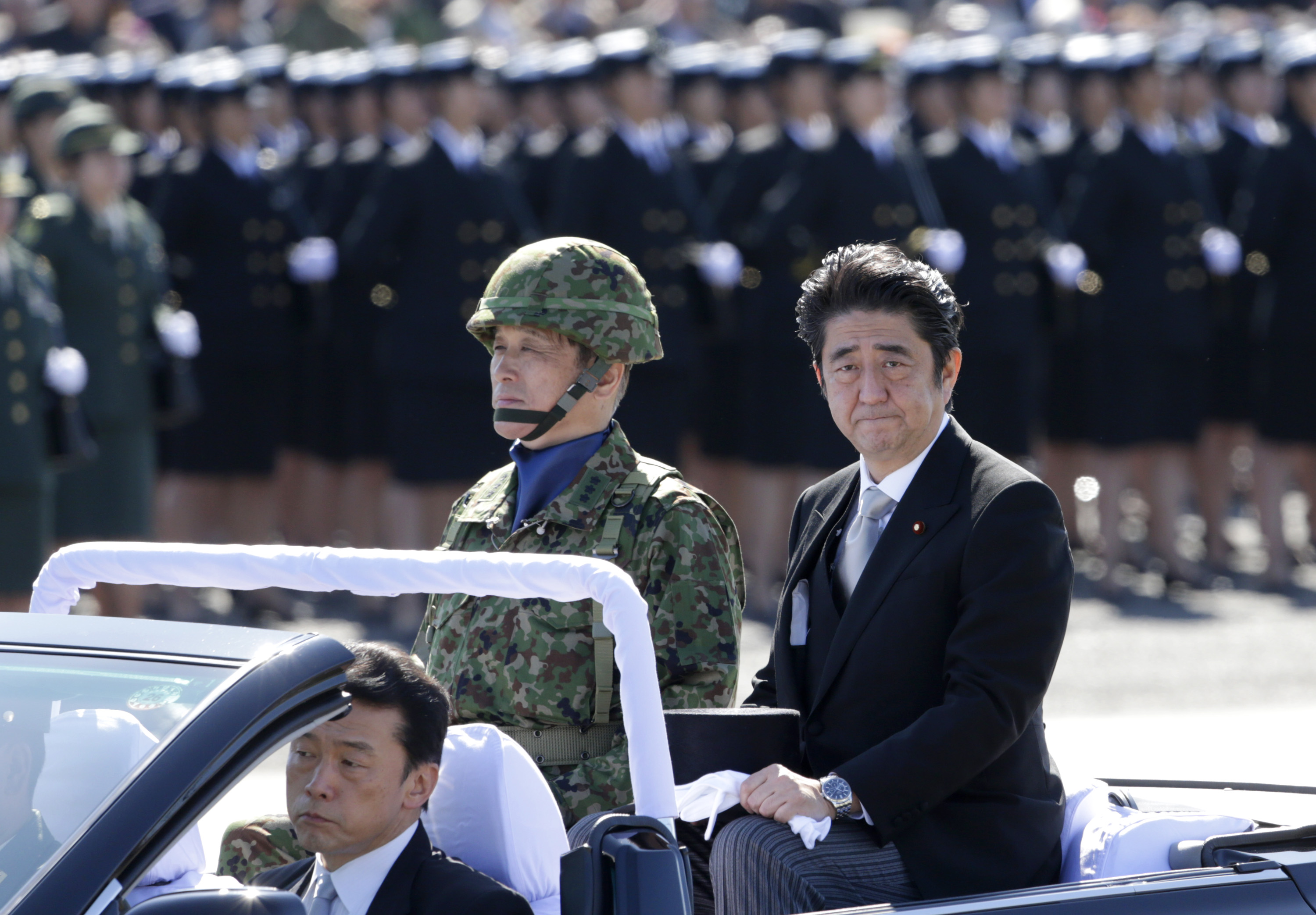 Prime Minister Shinzo Abe reviews members of Japan's Self-Defense Force (SDF) at Asaka Base, north of Tokyo, in September 2013. Photo: AP