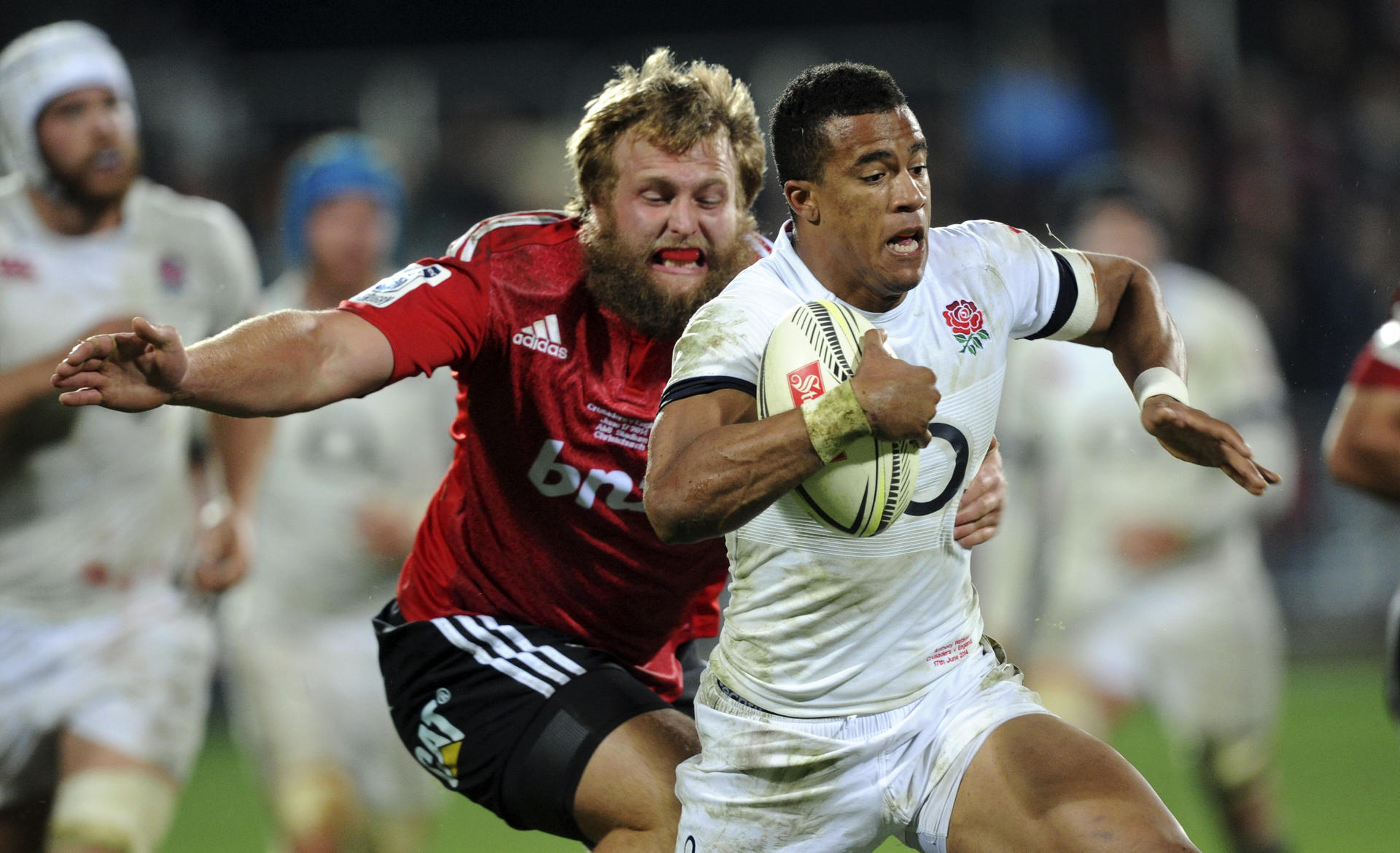 England's Anthony Watson outpaces Crusaders' Joe Moody in their match at Christchurch. Photo: AP