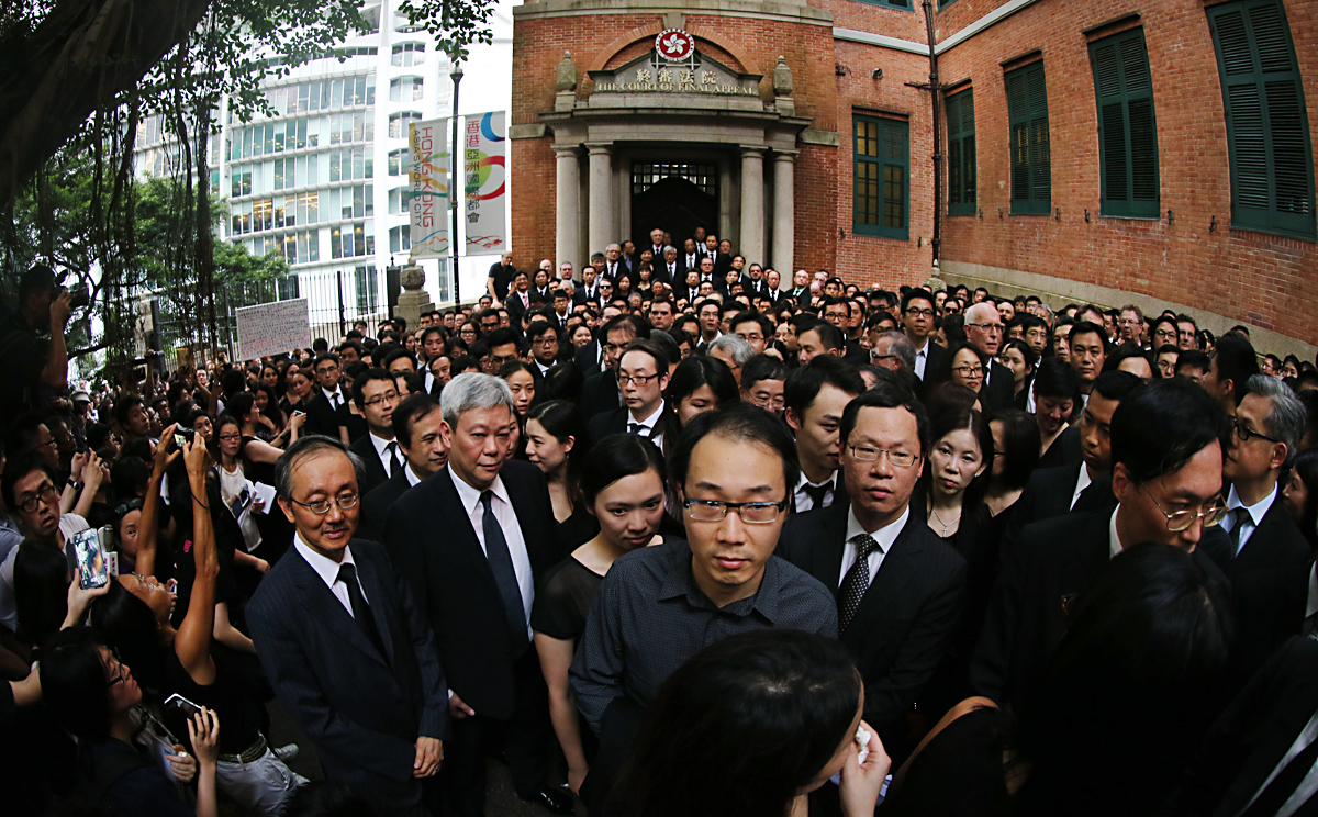 Lawyers, dressed in black, march to the city's Court of First Appeal to defend judicial independence and oppose Beijing's white paper on the "one country, two systems" policy. Photo: K.Y. Cheng
