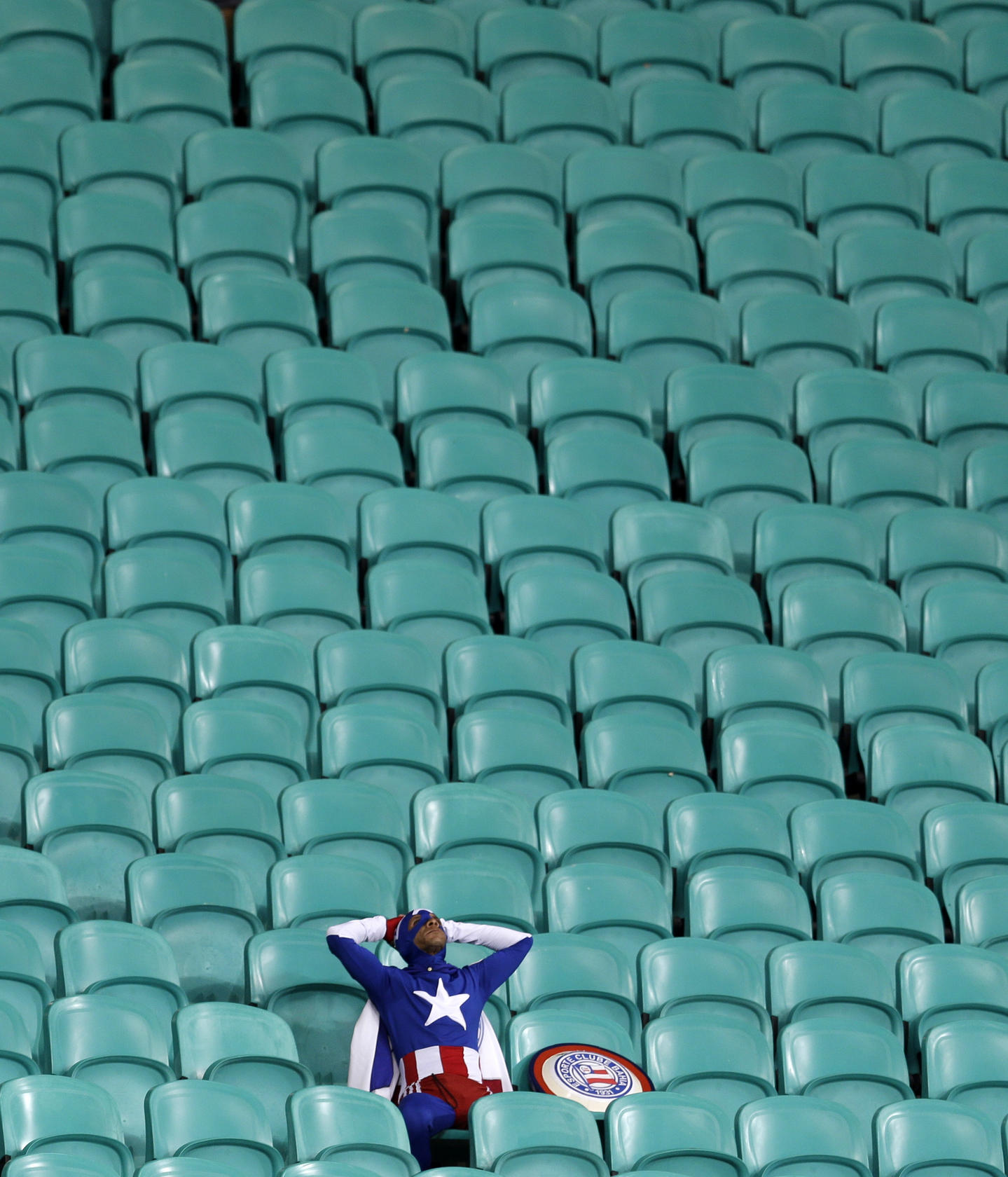 A lone US supporter in a Captain America costume is distraught at losing the battle after his team were beaten by Belgium. Photo: AP