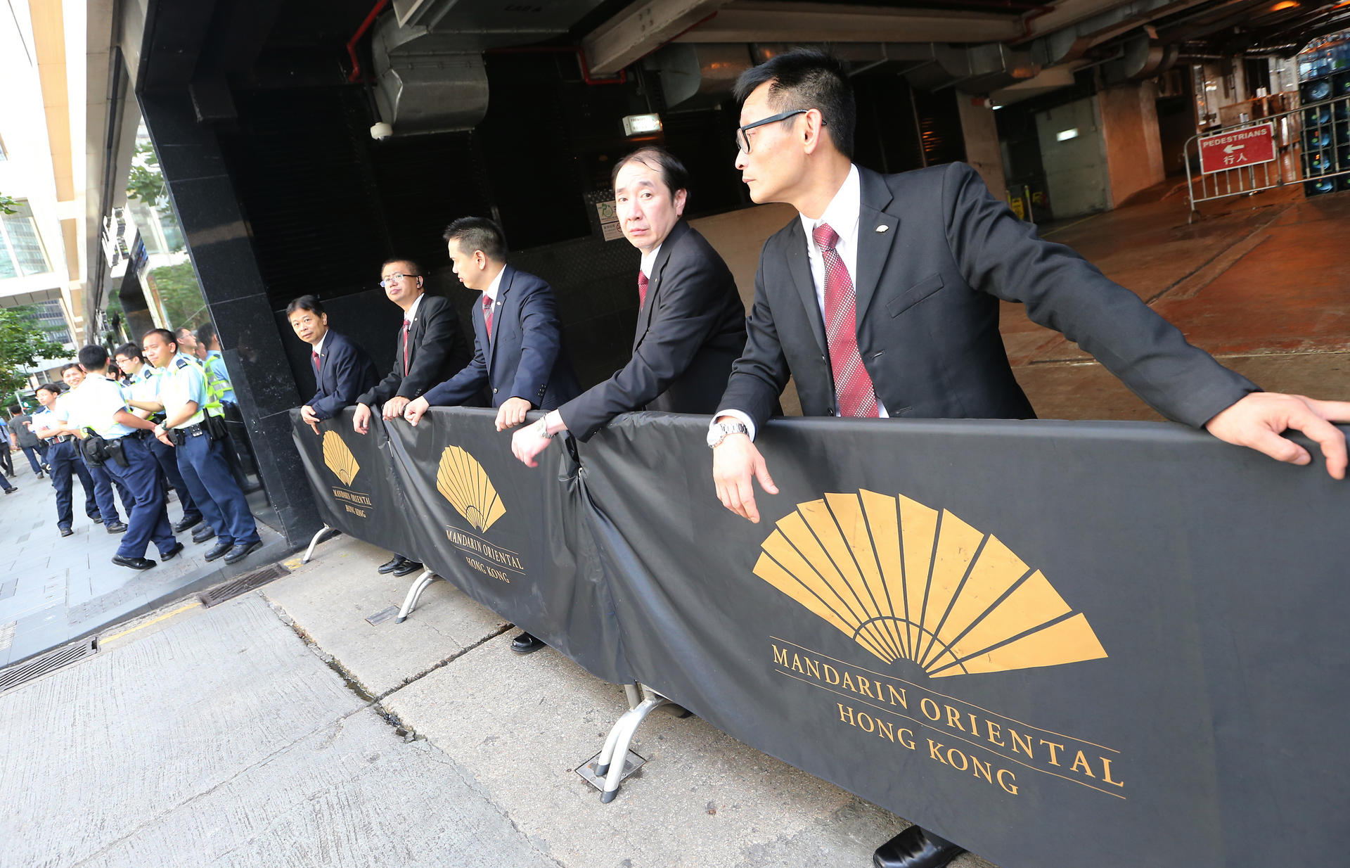 Hotel security guards and police officers keep watch outside the Mandarin Oriental. Photo: David Wong
