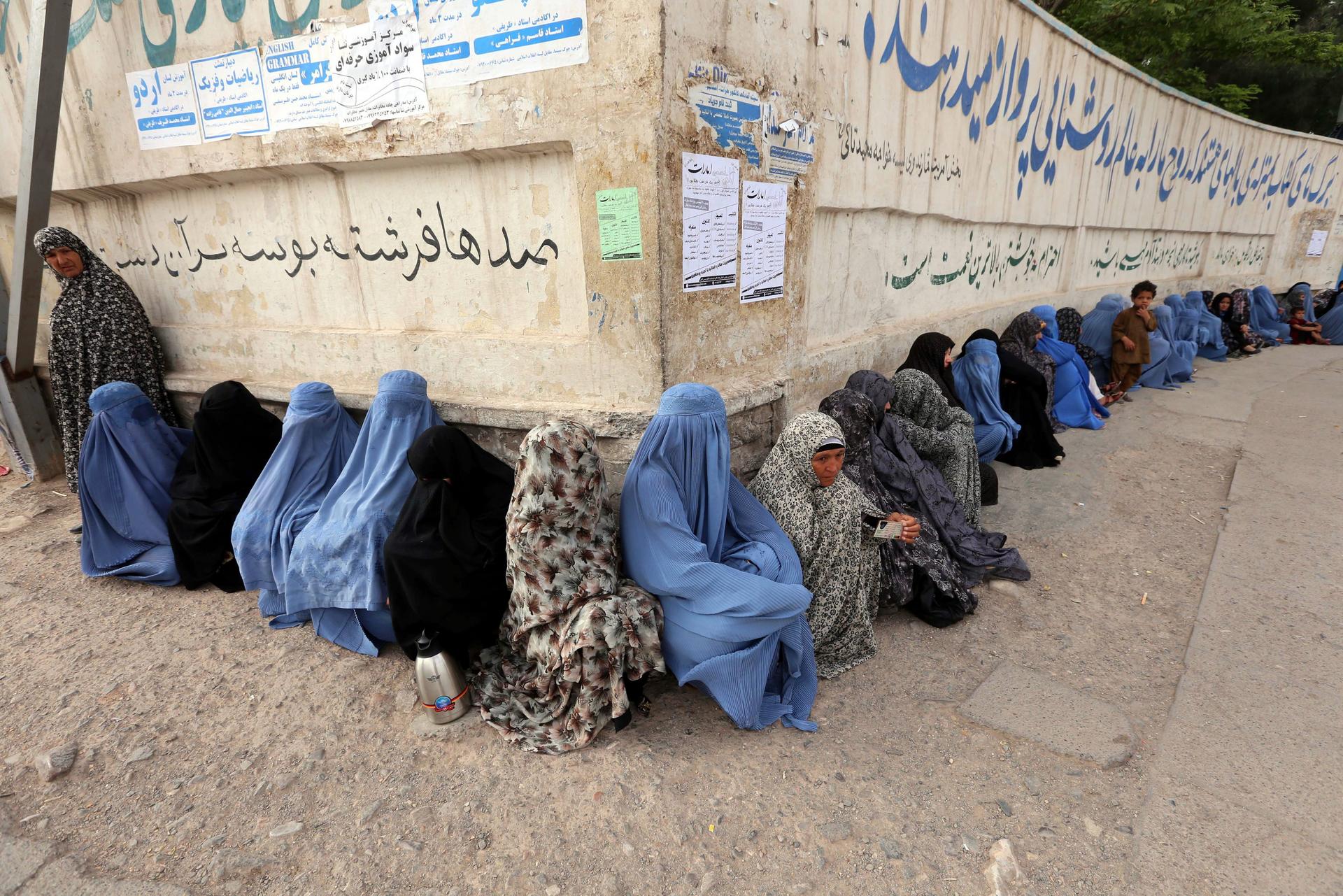 Burqa-clad women line up to vote during the presidential election run-off to replace Hamid Karzai in Afghanistan where Islamists want to curtail freedoms women have enjoyed for less than a generation. Photo: EPA