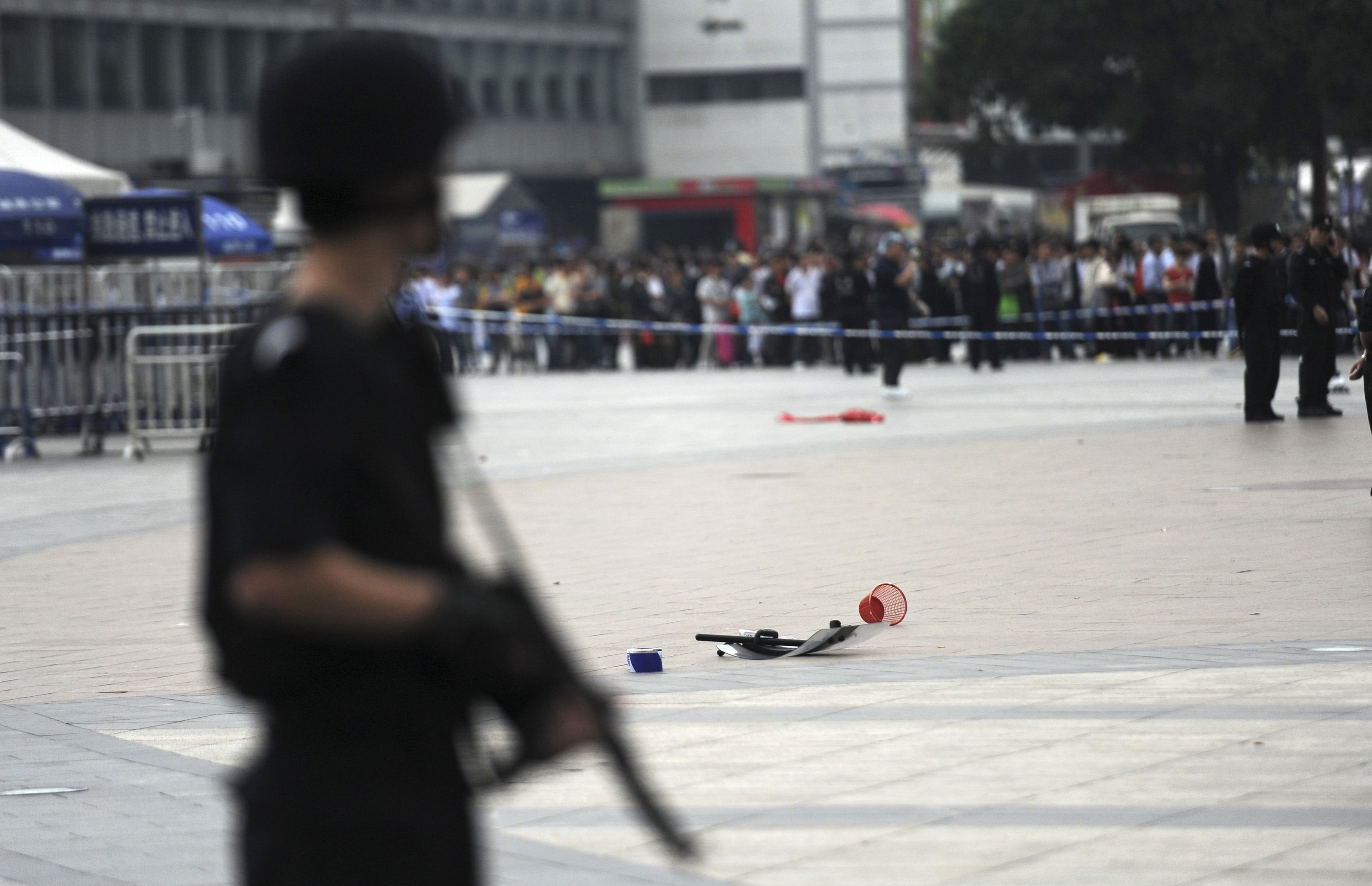 An armed policeman stands guard at a crime scene. A suspect was arrested today after a stand-off with police. Photo: Reuters