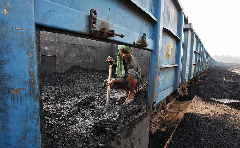 A worker unloads coal from a train at a railway yard in the northern India earlier this month. Photo: Reuters