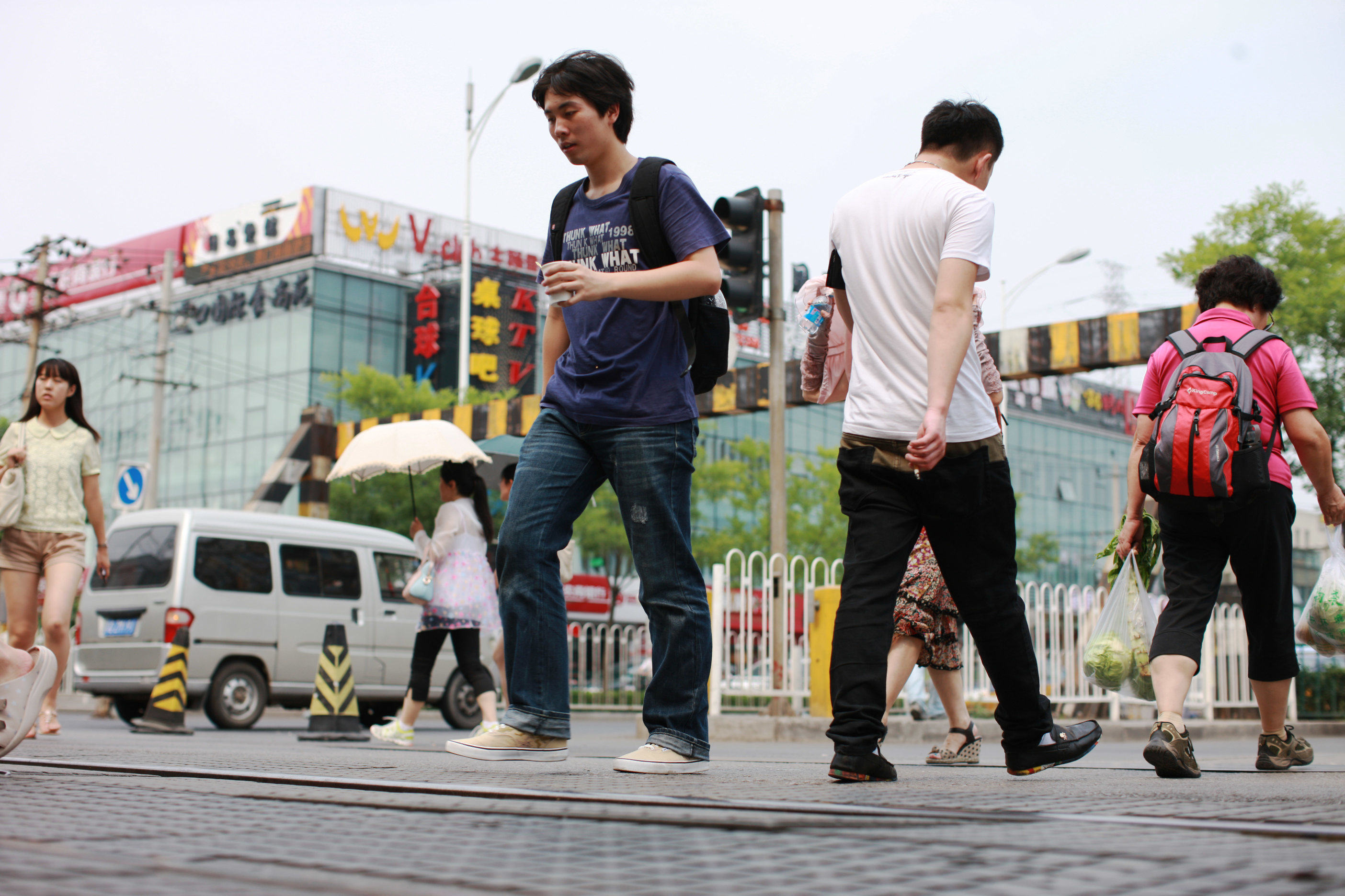 Pedestrians walk across the railway on Wudaokou in the Haidian District of Beijing. Photo: Xinhua