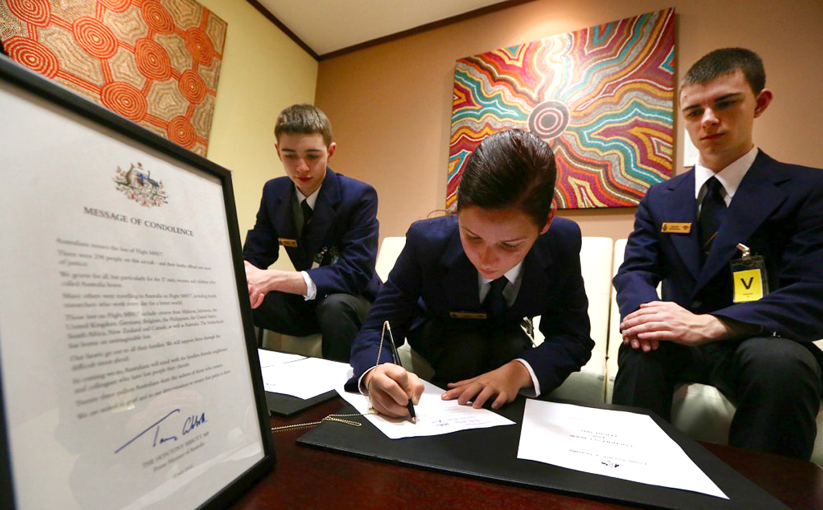 Australian Air Force cadets sign the book of condolence this morning in Wan Chai. Photo: Sam Tsang