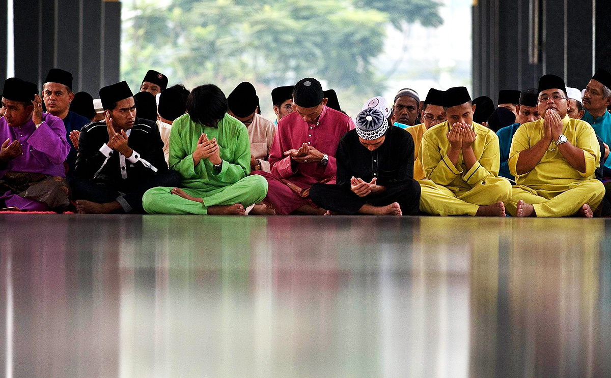 Malaysian Muslims offer prayers at the National Mosque. The victims of two air disasters were in the thoughts of many. Photo: AFP