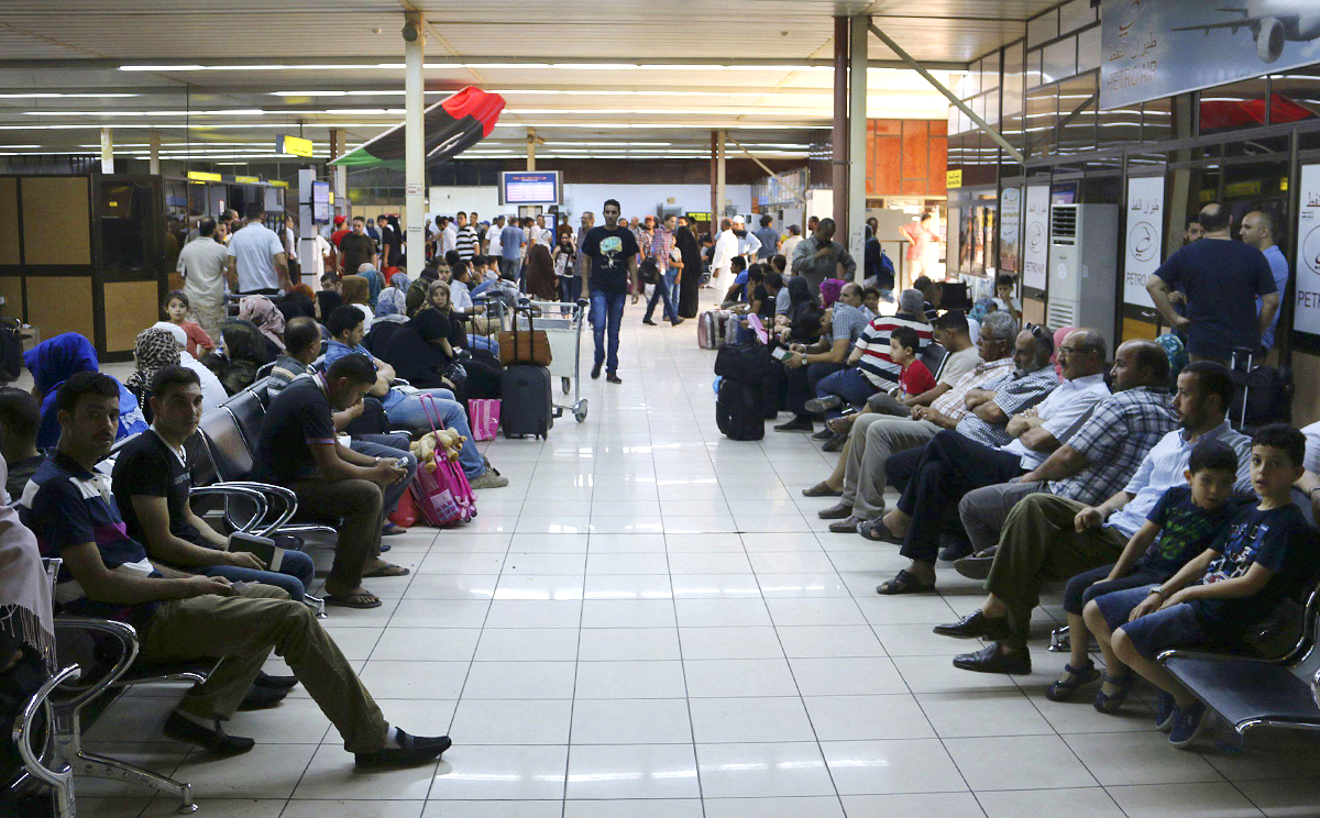 Passengers wait for flights in a hall at Tripoli's Mitiga airport, after clashes between rival militias closed Tripoli International Airport. Photo: Reuters