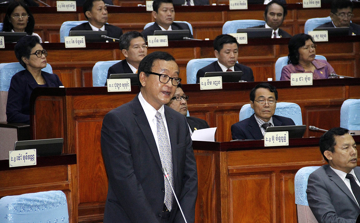Opposition leader Sam Rainsy (centre) speaks during the first full meeting of parliament since the end of a 10-month boycott at the National Assembly building in Phnom Penh on Friday. Photo: AFP