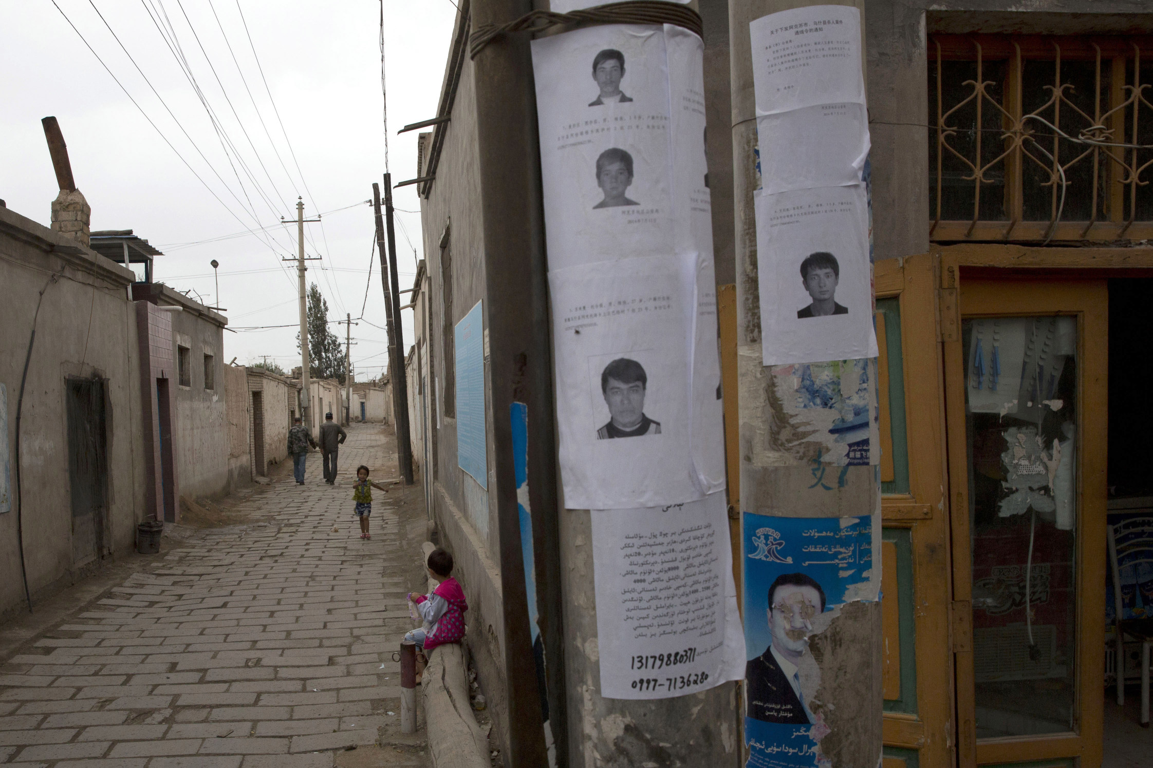 Wanted posters put up in Aksu, Xinjiang, of men suspected to be involved in terrorist attacks. Photo: AP