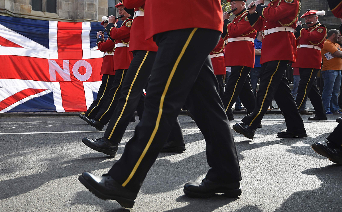 Band members march past a Union flag during a pro-Union rally in Edinburgh, Scotland on Saturday. Photo: Reuters