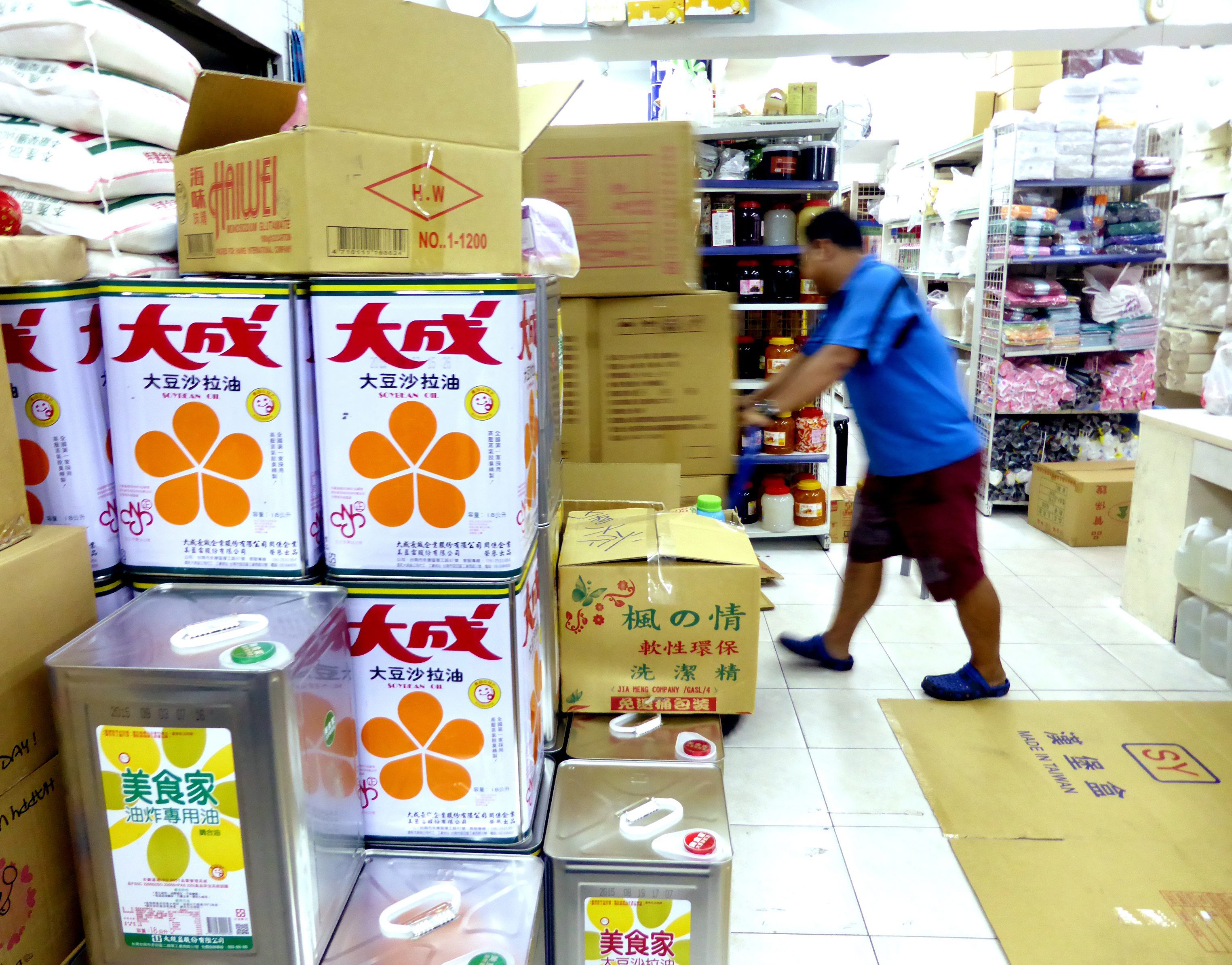 Cans containing cooking oil are stacked in a food retailer's shop in Taipei. Photo: EPA