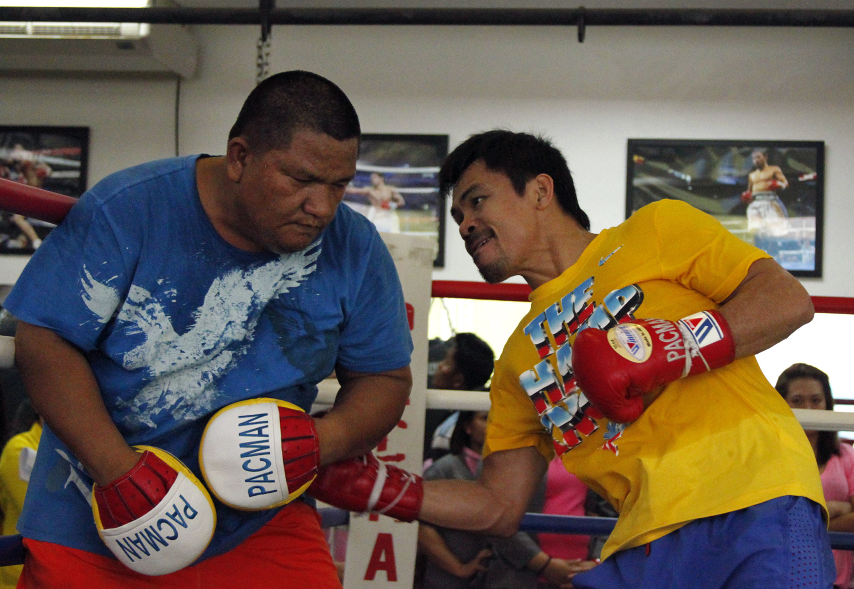 Manny Pacquiao (right) spars with assistant trainer Buboy Fernandes at a gym in General Santos City in Mindanao in preparation for his November bout with Chris Algieri. Photo: AFP 
