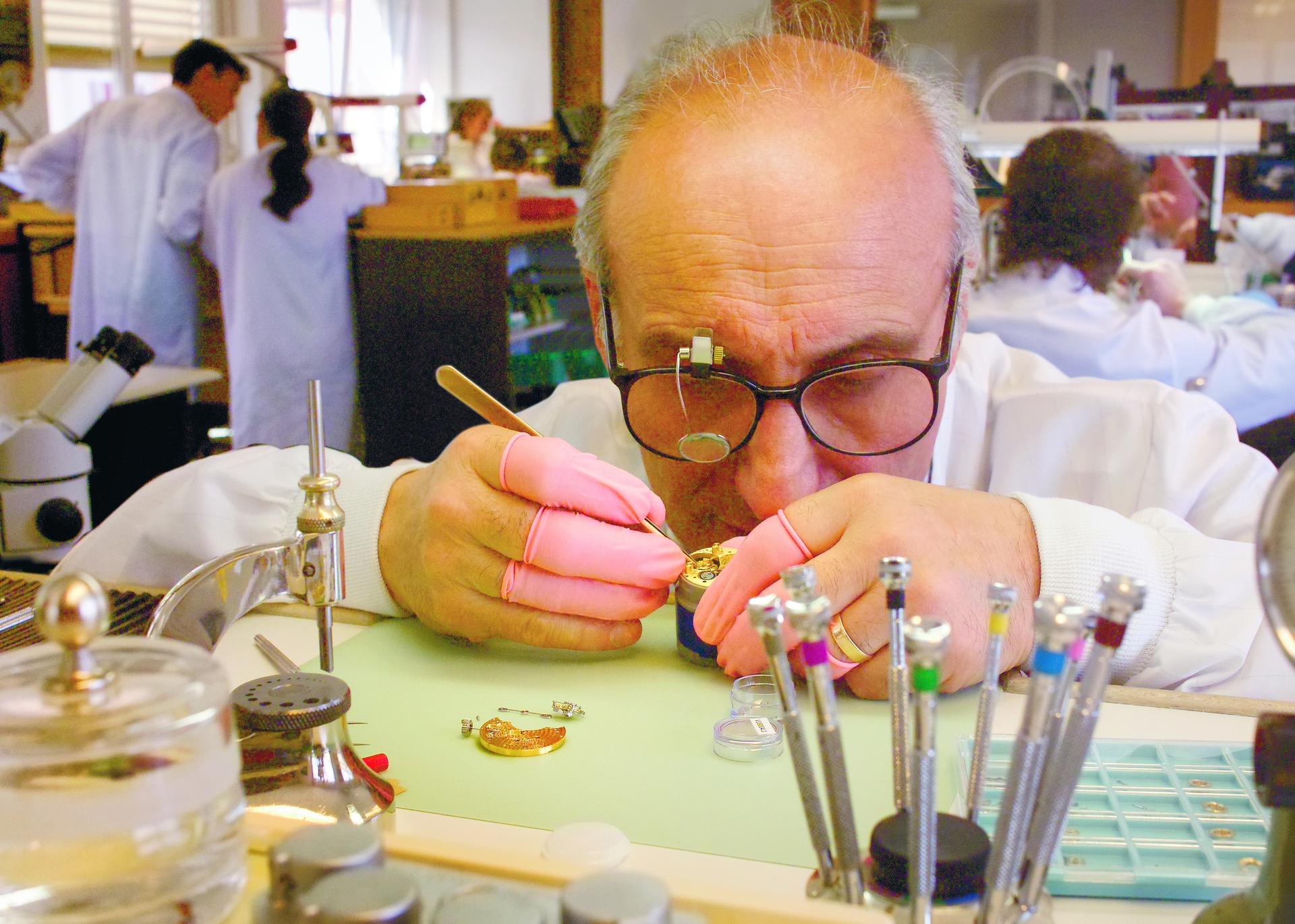 A Breguet craftsman concentrates on his complex work.