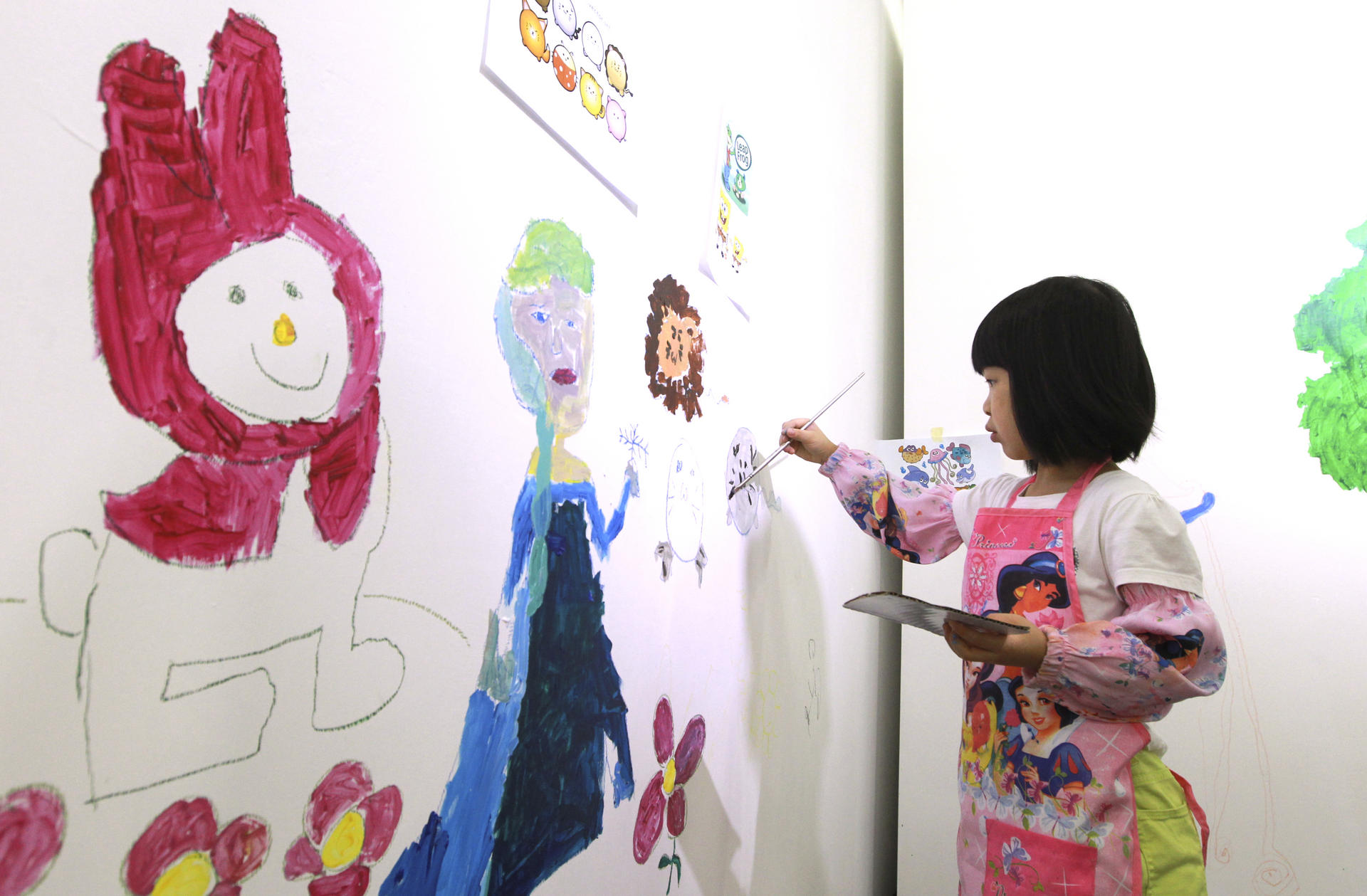 A child uses the wall at Artify, in Chai Wan, as her canvas. 