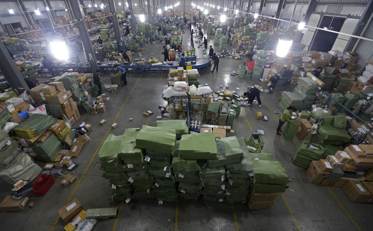 Employees sort packages along a convey belt at a hub of ZTO Express.