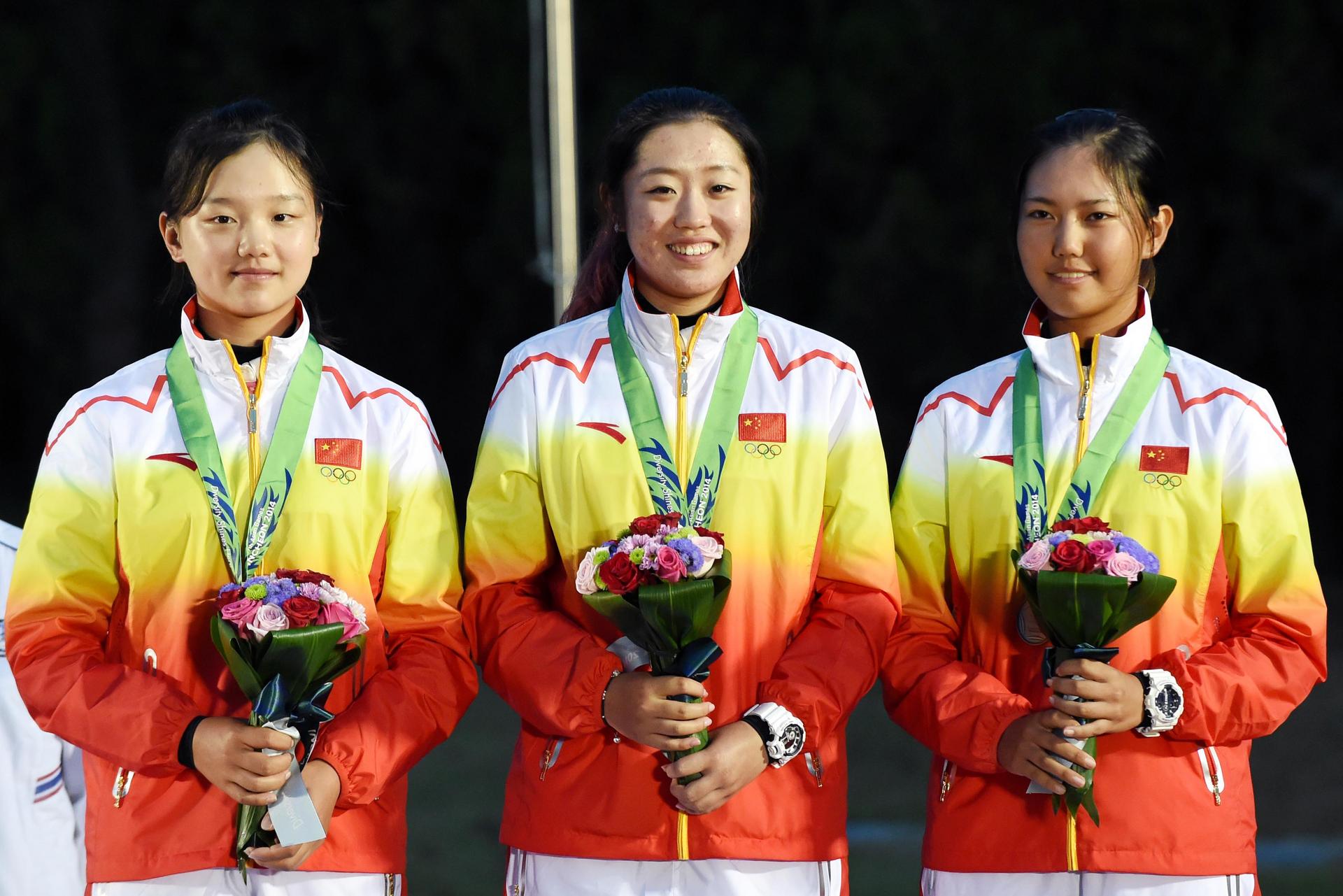 Bronze medallists Shi Yuting (left), Ye Ziqi and Wang Xinying of China pose on the podium during the awards ceremony for the women’s golf. Photo: Xinhua 
