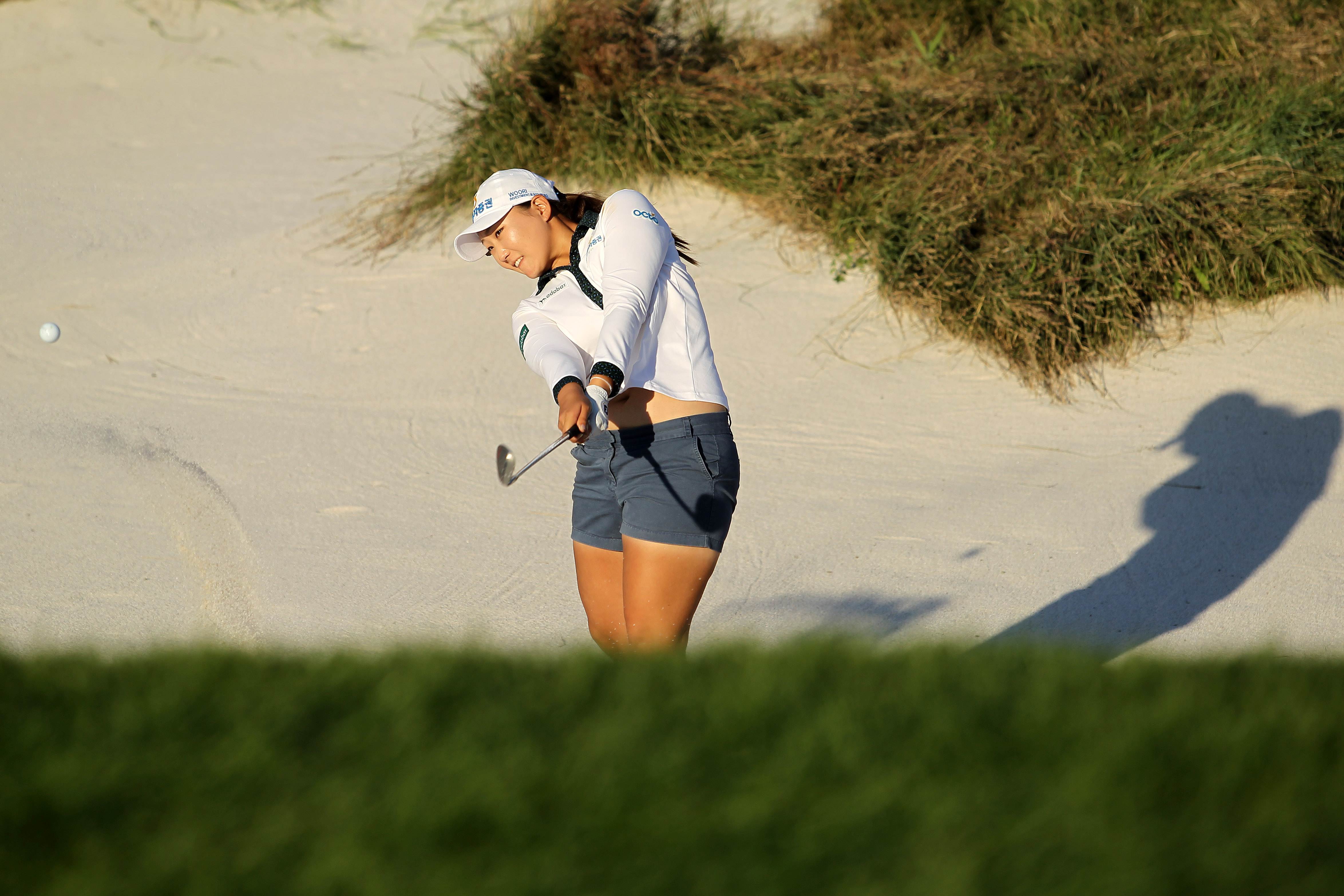 Mirim Lee of South Korea hits the ball from a sand trap during the final round at the Reignwood LPGA Classic at the Reignwood Pine Valley Golf Club near Beijing. Photo: AFP 