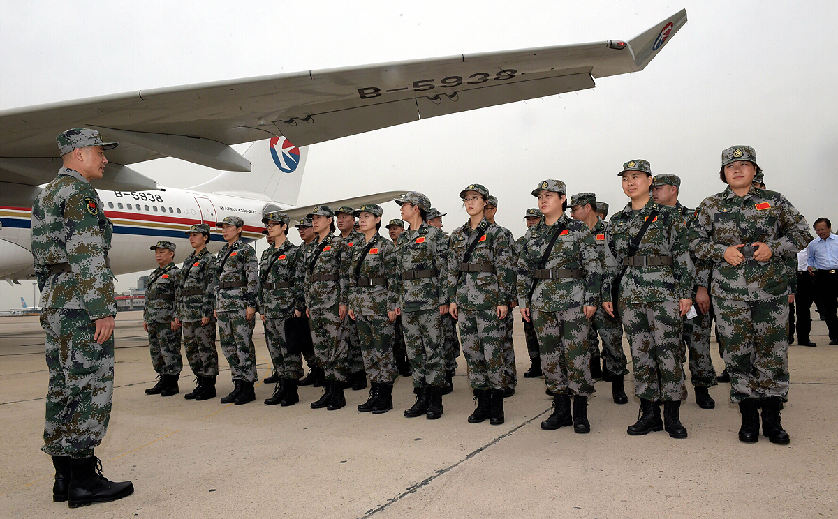 Members of a Chinese laboratory team line up in Beijing in mid September before departing for Sierra Leone to help contain the Ebola epidemic. Photo: Xinhua