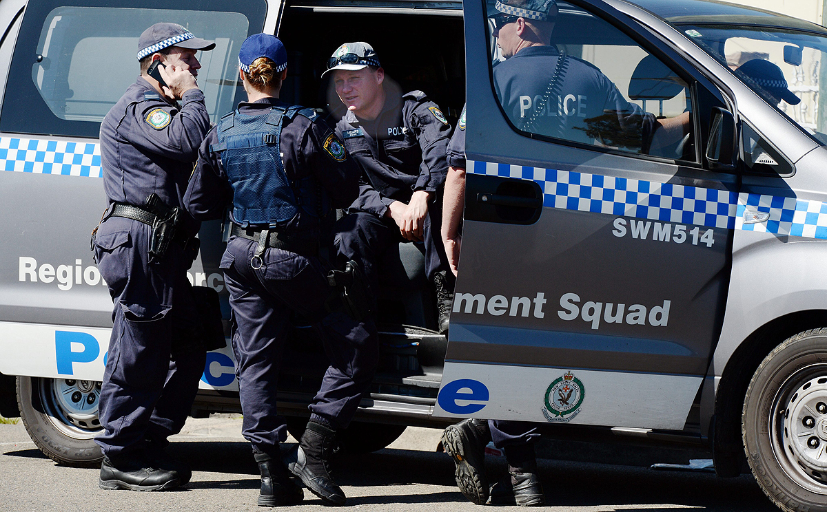 NSW Police and Australian Federal Police officers raid a house in Guildford, Sydney on September 18. Photo: EPA