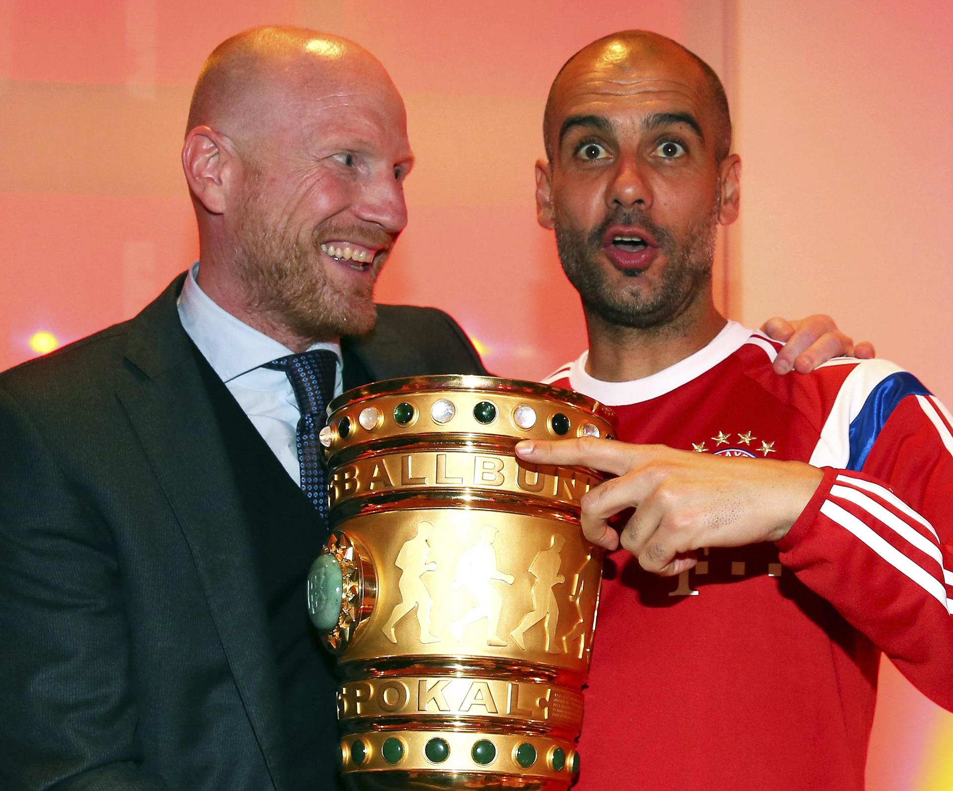 Pep Guardiola celebrates winning the German DFB Cup with Bayern's sports director Matthias Sammer in May, completing a domestic double. Guardiola is satisfied the squad are buying in to his system of play and he plans to continue his revolution with the Bavarian giants, as documented in Marti Peraranu's new book Pep Confidential, excerpted on this page. Photos: AFP, Reuters, EPA, AP