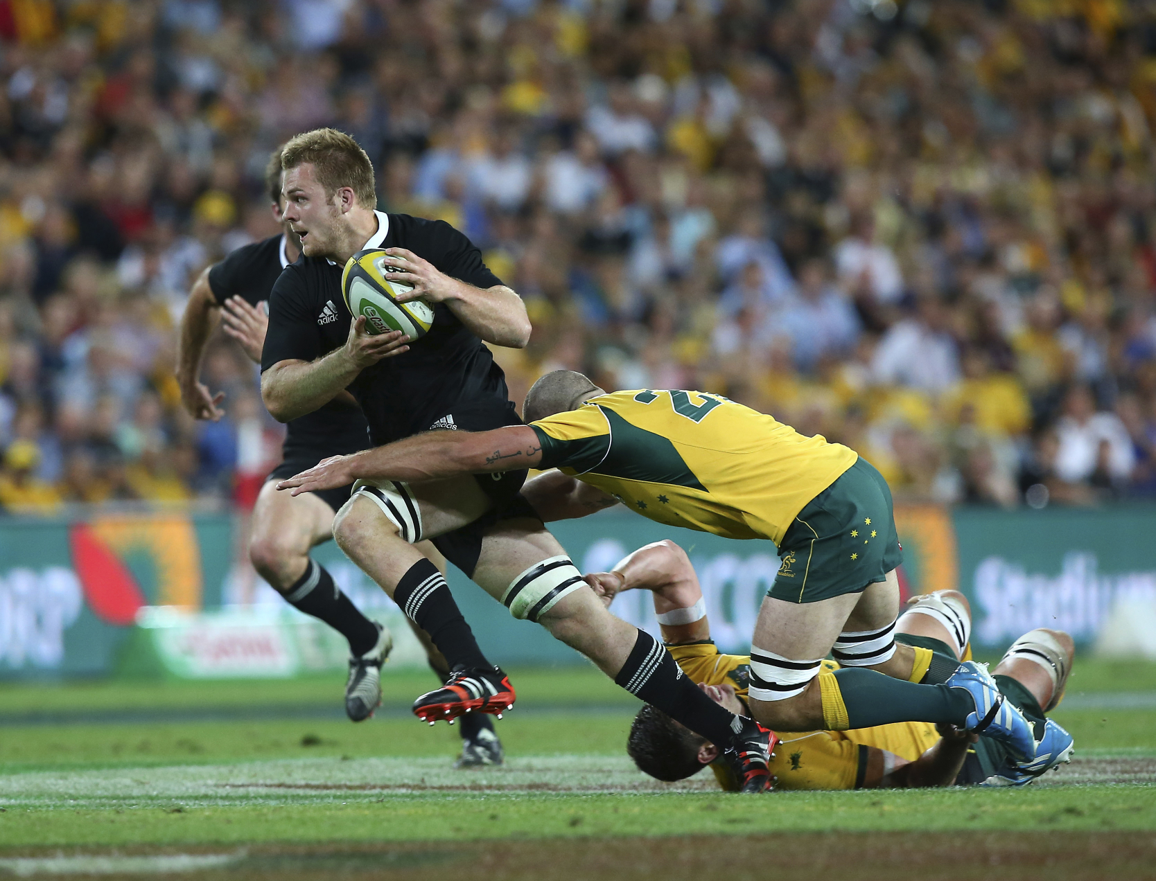 New Zealand's Sam Cane is tackled by Matt Hodgson of Australia during their Bledisloe Cup clash in Brisbane on Saturday. Photos: AP
