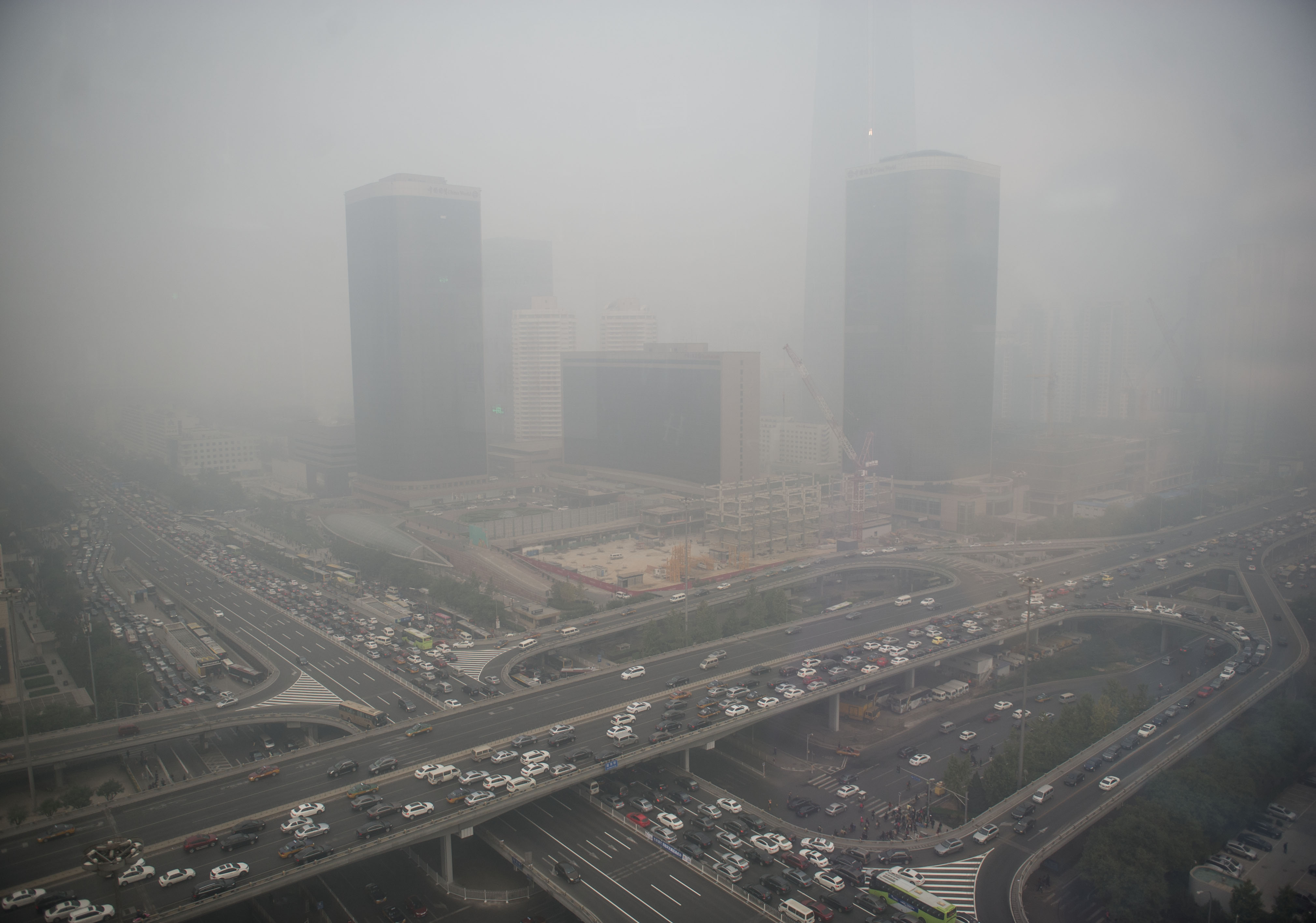 Smog shrouded buildings and streets in Beijing, China. Photo: Xinhua