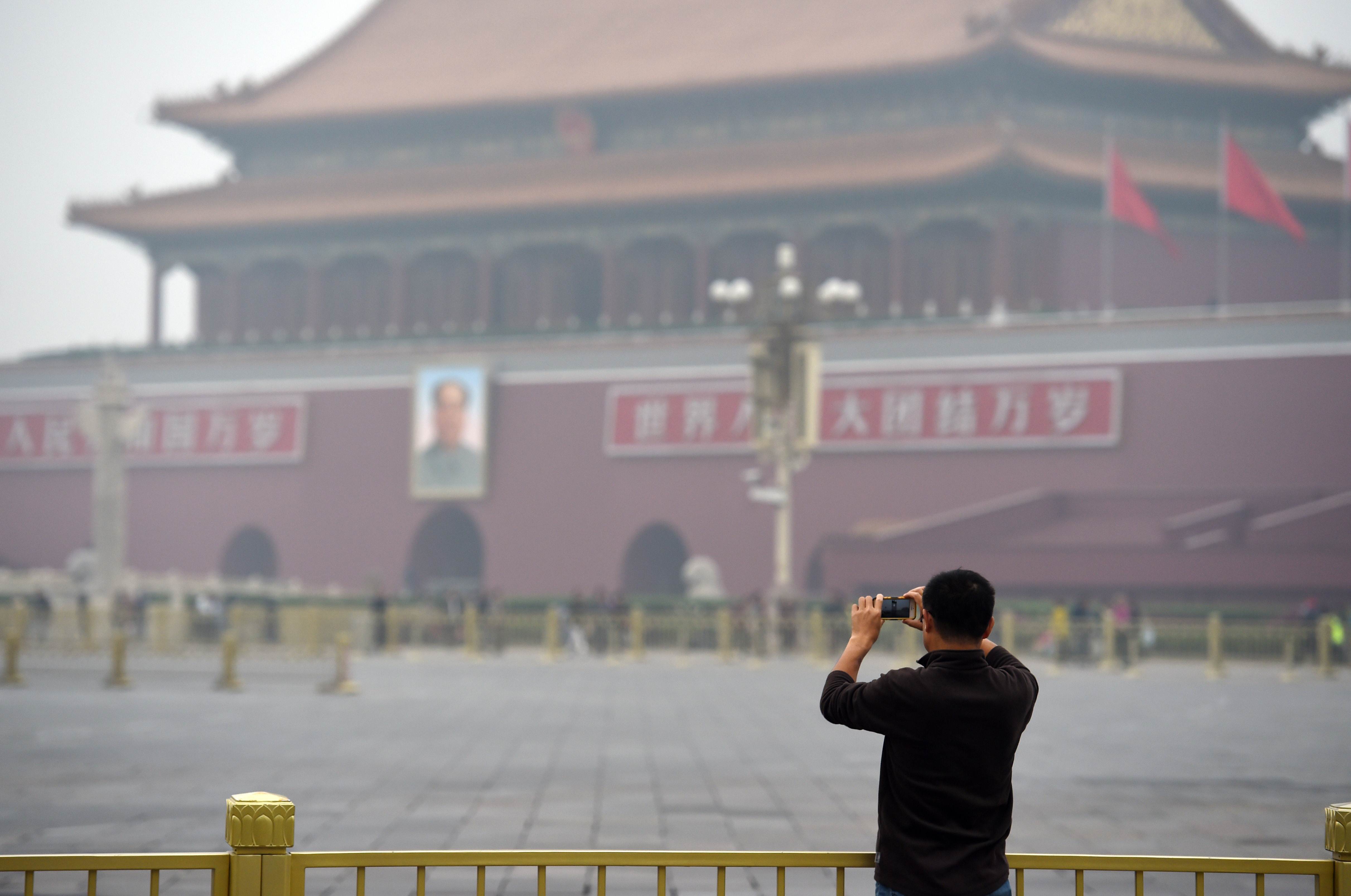 A man takes photos of Tiananmen Gate on Saturday. Photo: AFP