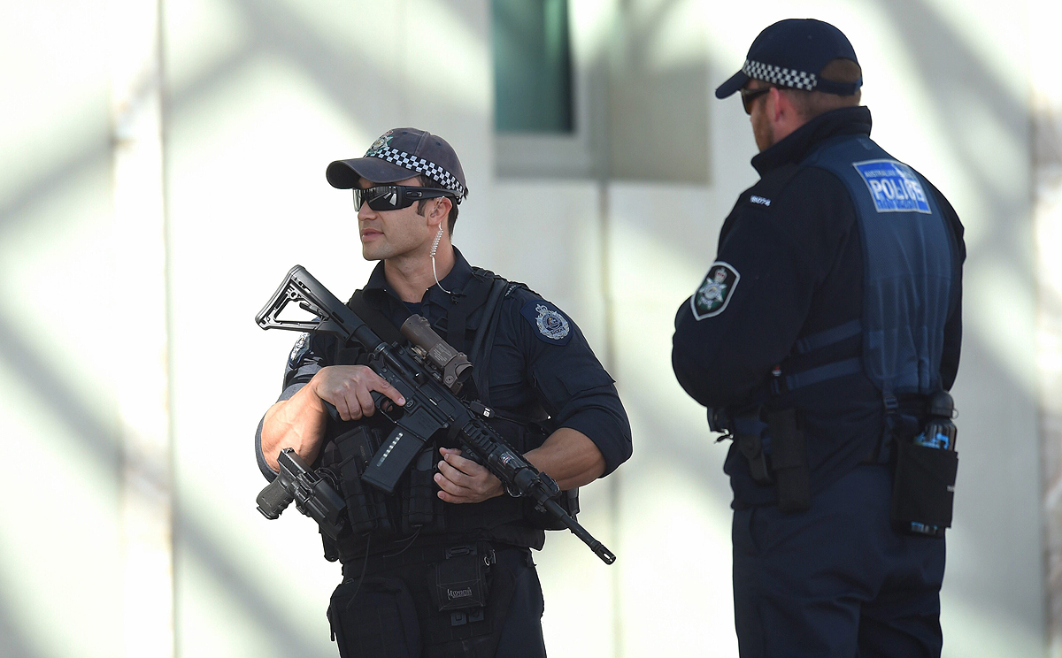 Heavily-armed Australian Federal Police officers at the entrance to Parliament House in Canberra on Thursday. Photo: EPA